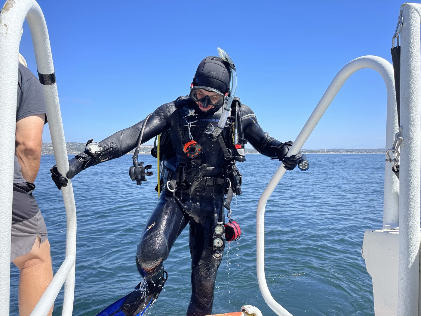 A diver climbing the Marissa's fin ladder back aboard