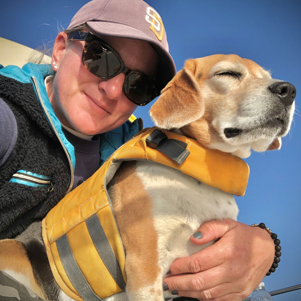 Captain Lora with Captain the beagle aboard the Marissa