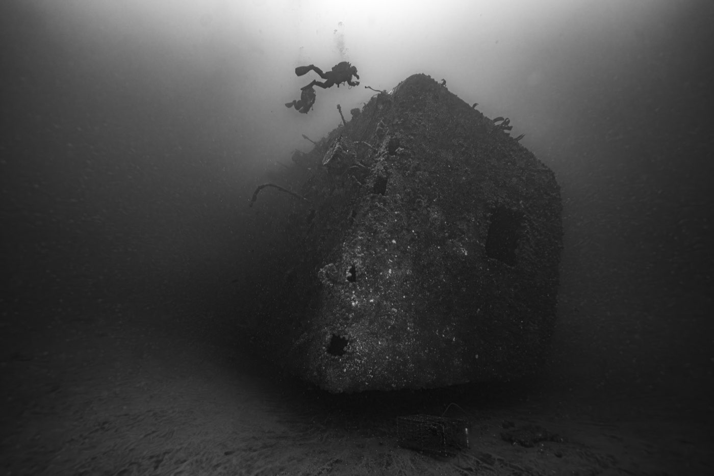The Yukon's stern standing on the sand in low visibility, a lobster trap beside it